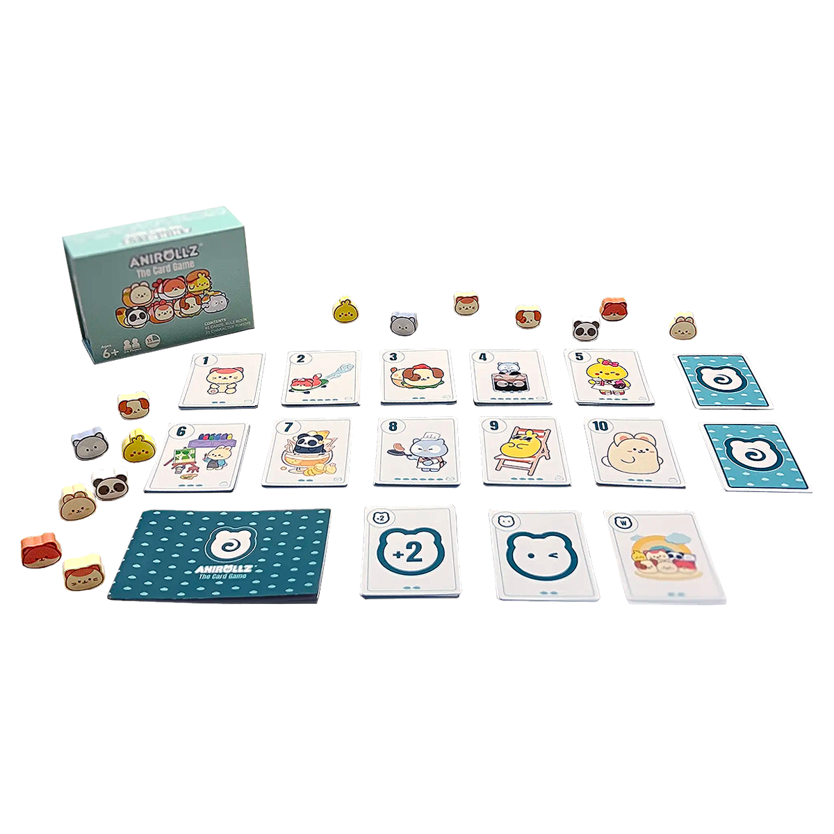 Anirollz The Card Game contents spread out, including the game box, rulebook, numbered cards 1–10 featuring kawaii Anirollz characters, special action cards, and 21 small wooden character tokens
