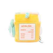 Side of orange juice carton plush with a printed nutrition facts: sweetness, cuteness, and softness 100%