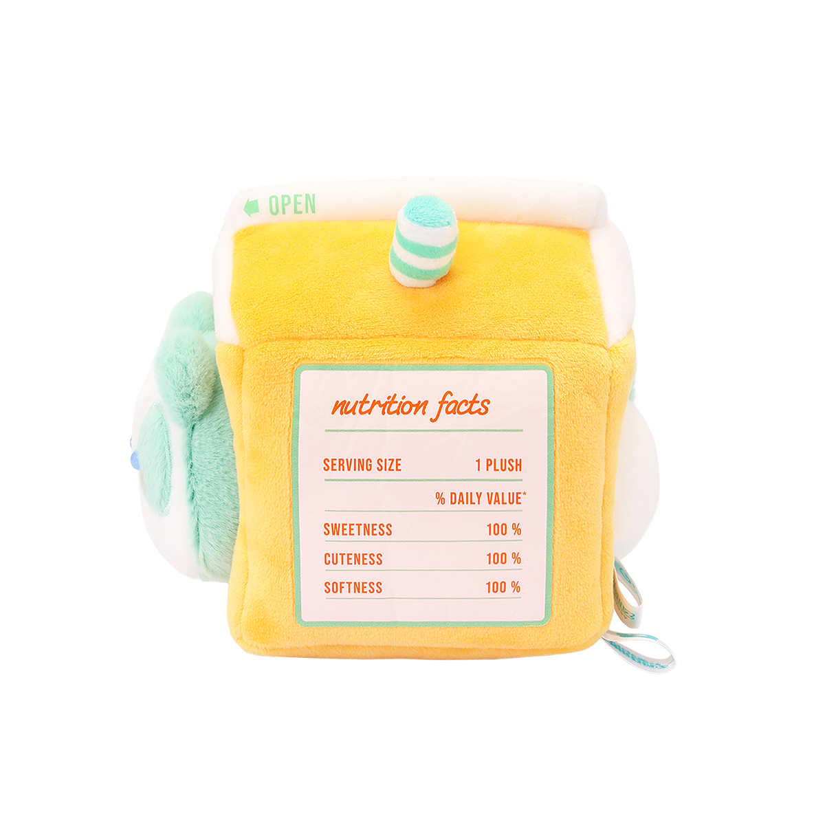 Side of orange juice carton plush with a printed nutrition facts: sweetness, cuteness, and softness 100%